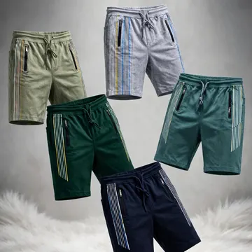 Five pairs of men's athletic shorts in various colors are displayed floating above a white furry surface against a gray studio background