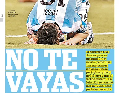 Soccer player in blue and white jersey kneeling on grass with head down