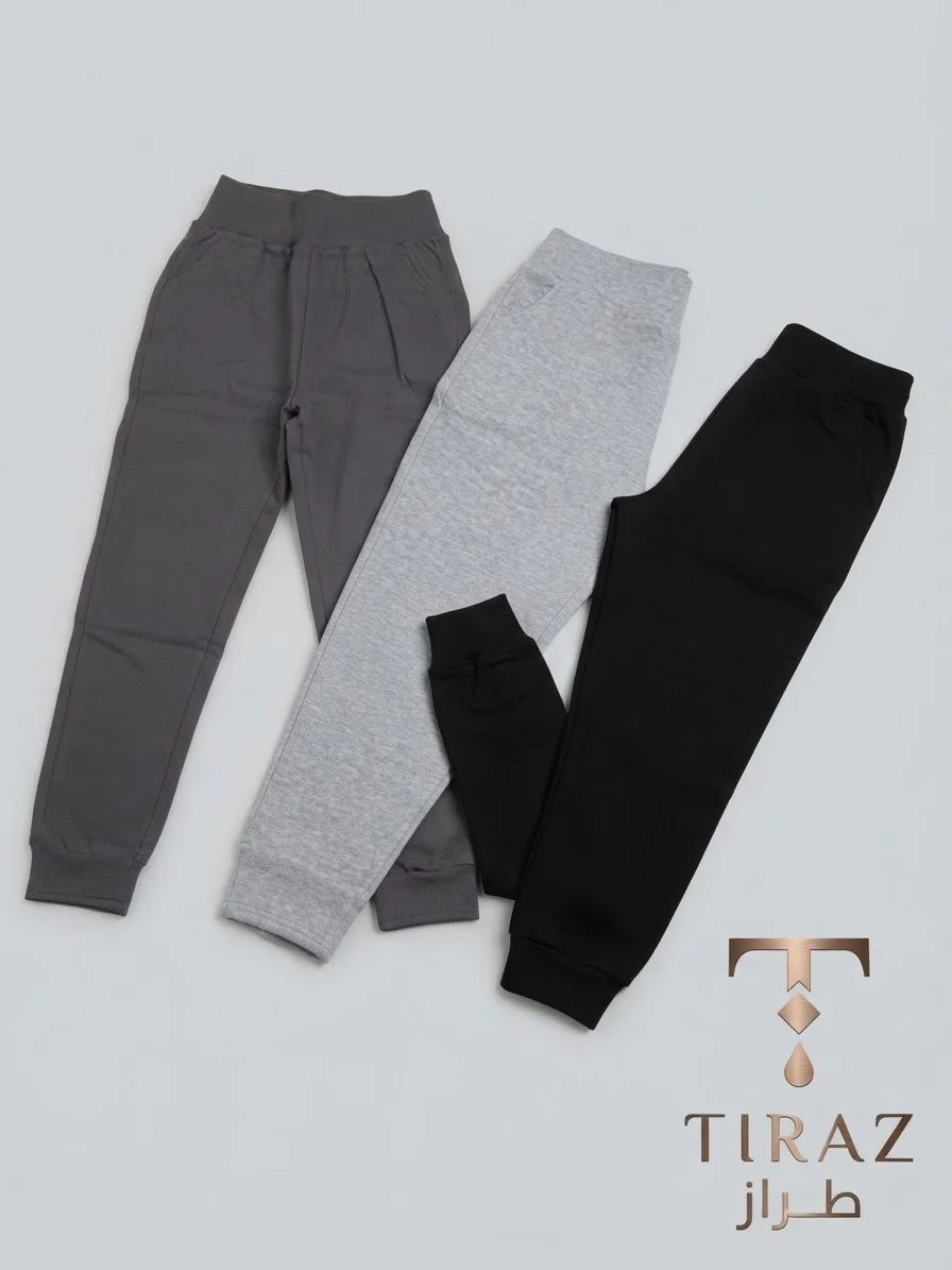 Three pairs of children's joggers in charcoal gray heather gray and black on light gray background