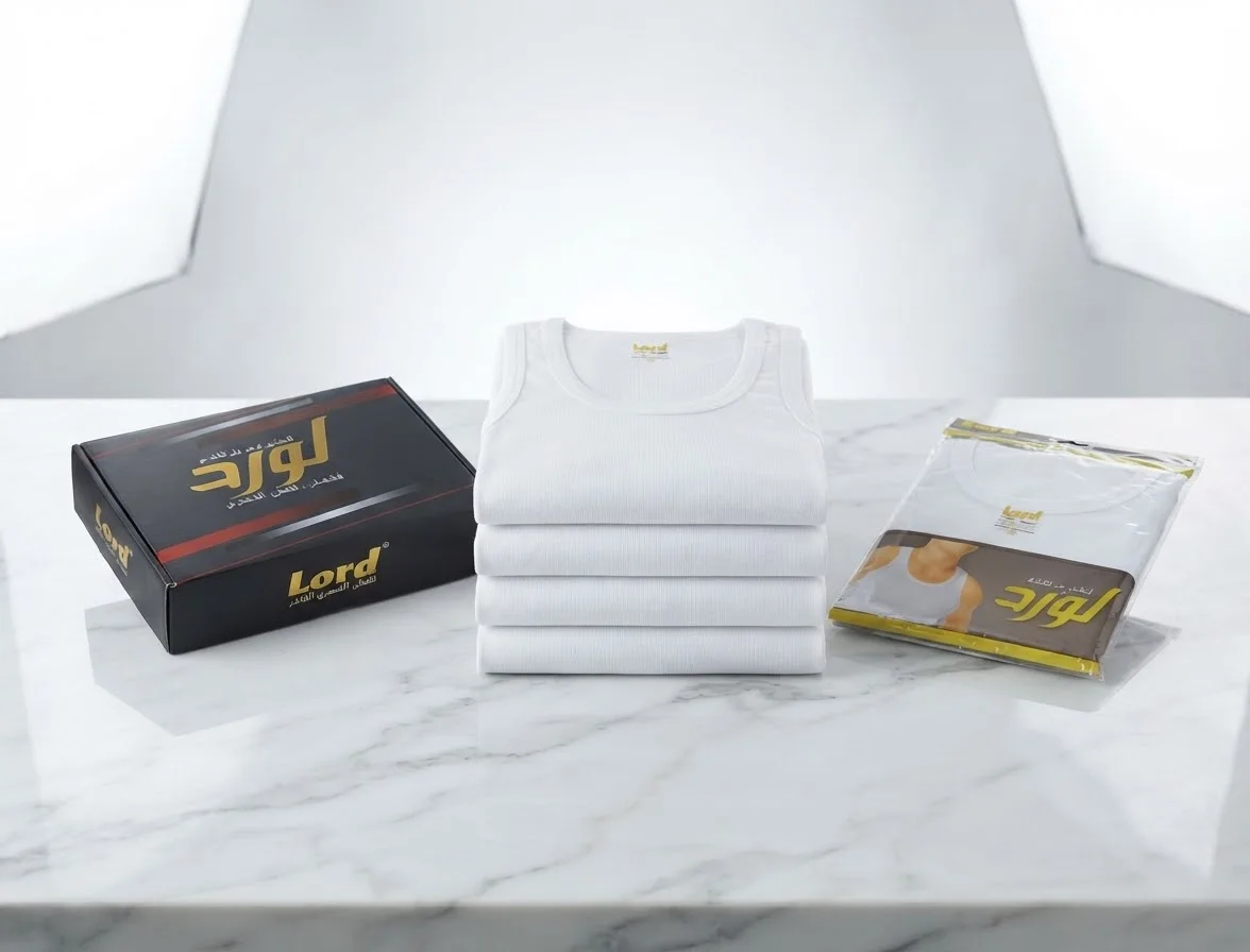 Stack of white undershirts and branded packaging on marble surface