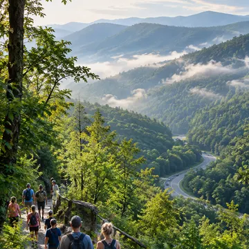 Group of hikers walking on a rocky trail through forest with misty mountains and winding road below