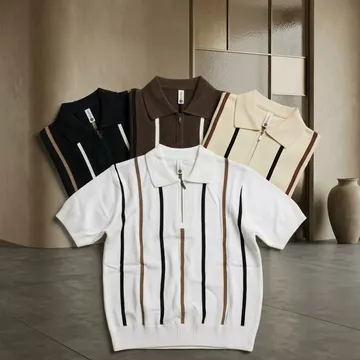 Four striped knit polo shirts displayed on a modern tiled floor with a vase and beige wall