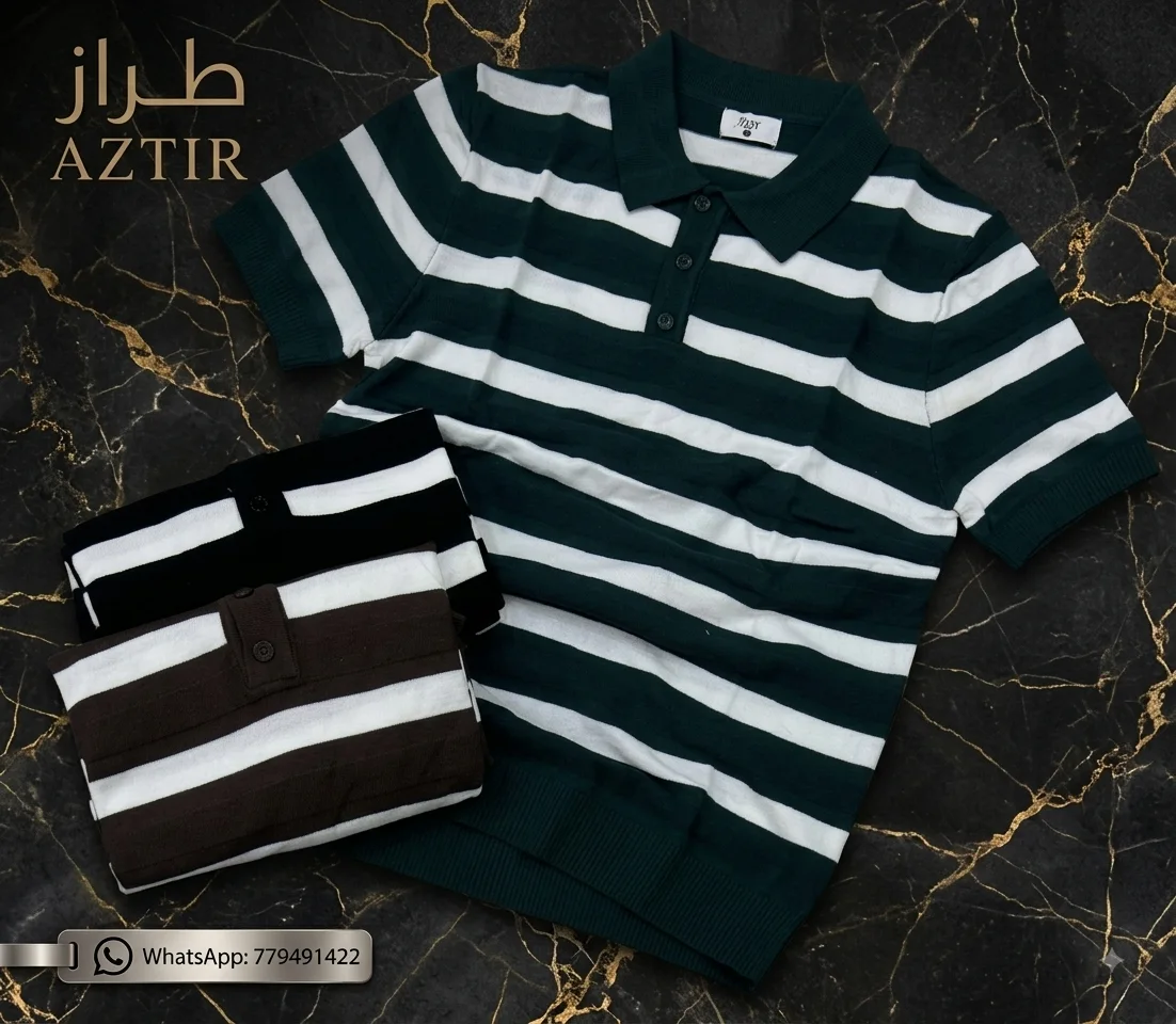 Two folded striped polo shirts on dark gold marble surface