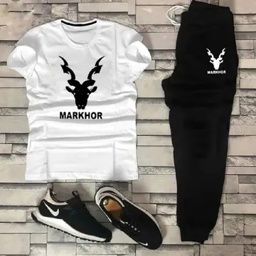 White tshirt black sweatpants and black sneakers with markhor logo on gray brick background