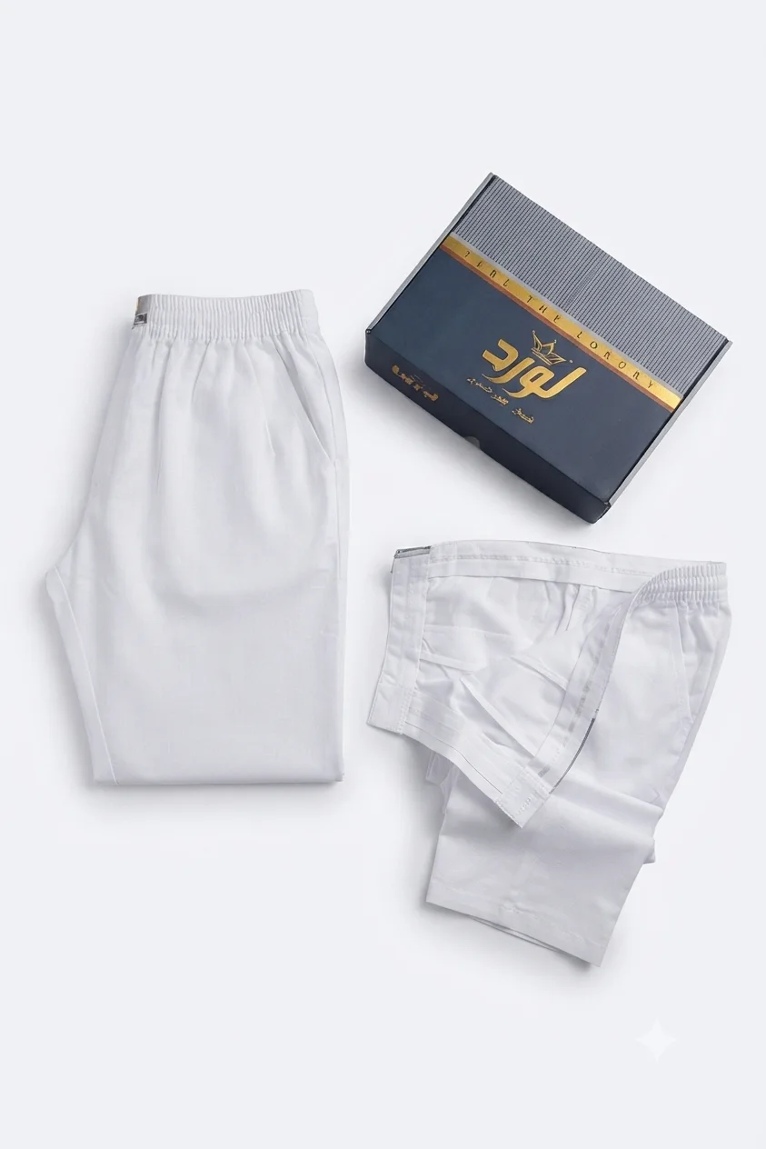 Two folded white lounge pants with branded packaging on a clean white background