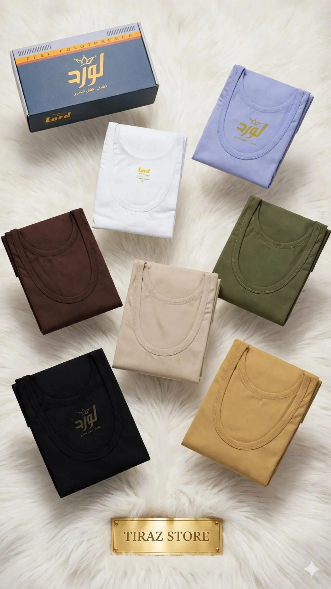 Seven folded t-shirts in various colors are arranged on a white furry surface, with a branded box and a 'TIRAZ STORE' plaque visible