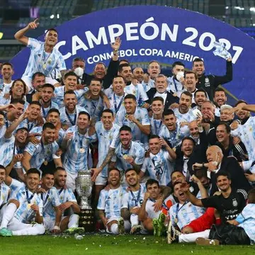 Argentina football team celebrates Copa America 2021 victory with trophy and confetti on field