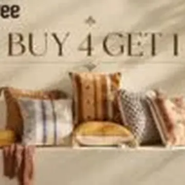 Row of patterned pillows in earth tones on a white shelf with a promotional sign above
