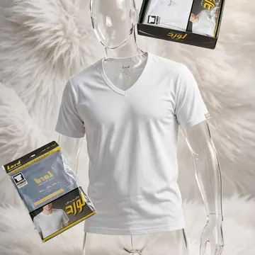 A clear plastic mannequin wearing a white V-neck T-shirt is displayed on a fluffy white surface, with product packaging and a branded box nearby