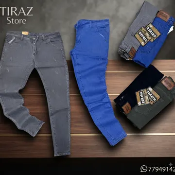 Four pairs of men's jeans in gray blue black and olive green displayed on a wooden surface