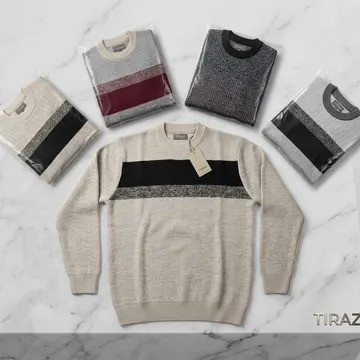 Five packaged sweaters and one beige striped sweater on a marble surface