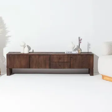 Dark wood console with white vases and book against white wall