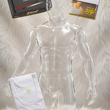 Clear mannequin with white undershirts and packaging on fluffy white fur with gold store sign