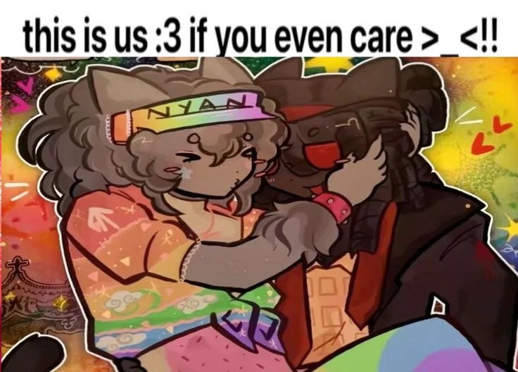 Two cartoon characters with cat ears embrace warmly against a rainbow background with hearts and stars