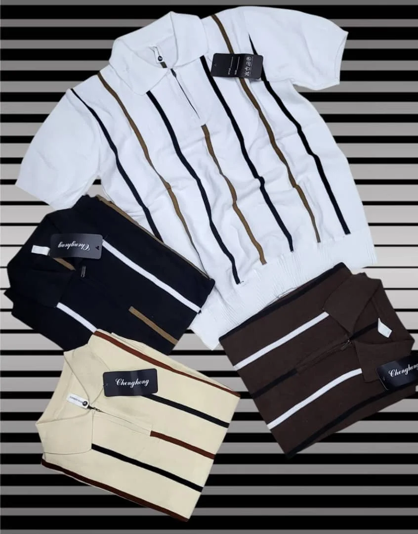 Four folded striped polo shirts with brand tags on striped background