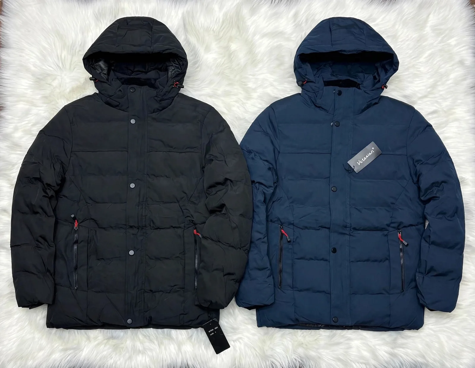 Two winter puffer jackets black and navy blue with red zippers on white fur