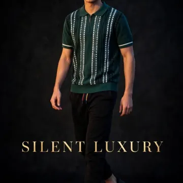A young man in a green patterned polo and black joggers walking in a studio with gold text